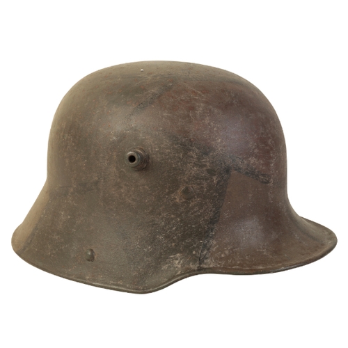 494 - A WWI GERMAN CAMOUFLAGE HELMET with the original leather lining, stamped to the interior 