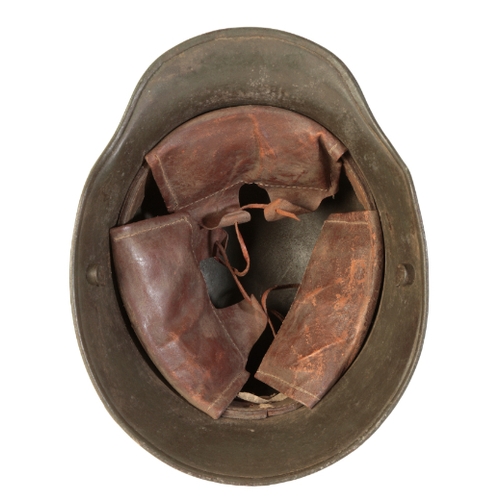 494 - A WWI GERMAN CAMOUFLAGE HELMET with the original leather lining, stamped to the interior 