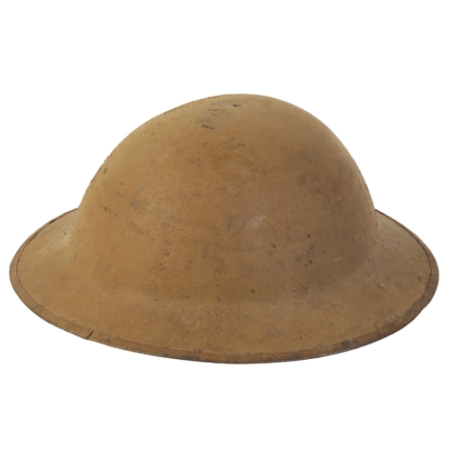 495 - A WWI BRODIE HELMET with a leather chin strap and leather interior, size 7 1/4