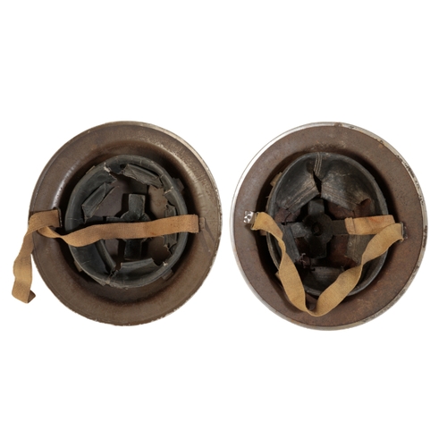 496 - TWO WWII BRITISH ARMY HELMETS with original lining and canvas chin straps; and one spike socket bayo... 