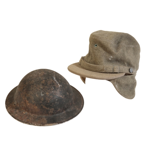 505 - A MILITARY FIRE SERVICE TIN HELMET with the original leather lining and canvas chin strap; a felt in... 