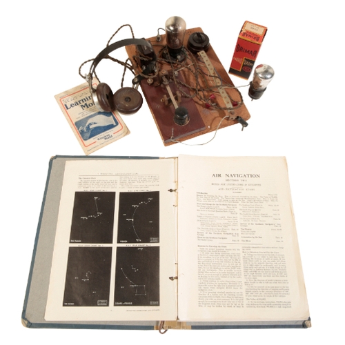 606 - A MORSE CODE MACHINE mounted on an oak board, with bone switch and lightbulb, together with a Learni... 