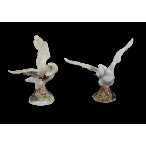 102 - AN OPPOSING PAIR OF 19TH CENTURY MEISSEN SWANS modelled with wings outstretched on rocky bases, each... 