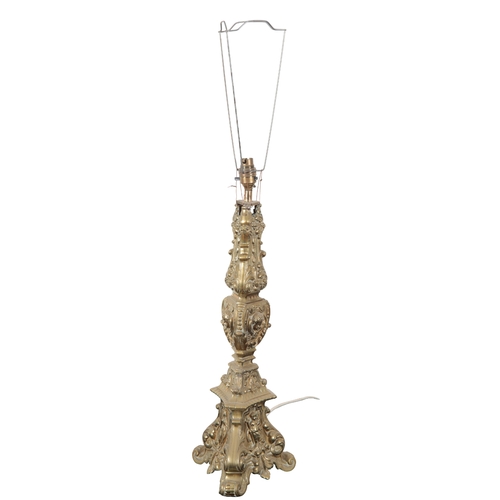 144 - TWO SIMILAR CONTINENTAL BRASS ALTAR LAMPS both of tripod form, decorated to the base with figural re... 