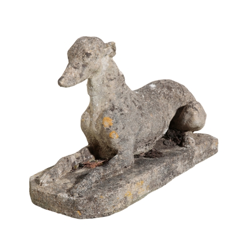 18 - A PAIR OF RECONSTITUTED  STONE GREYHOUNDS on plinth bases, each 41cm high x 67cm wide (2)