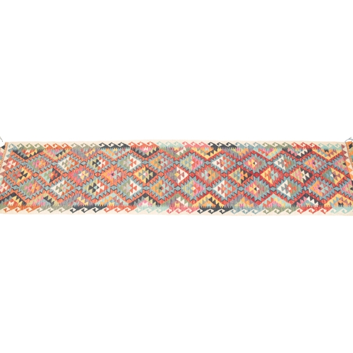 348 - AN ANATOLIAN TURKISH KILIM RUNNER the polychrome ground with all over geometric decoration, within c... 