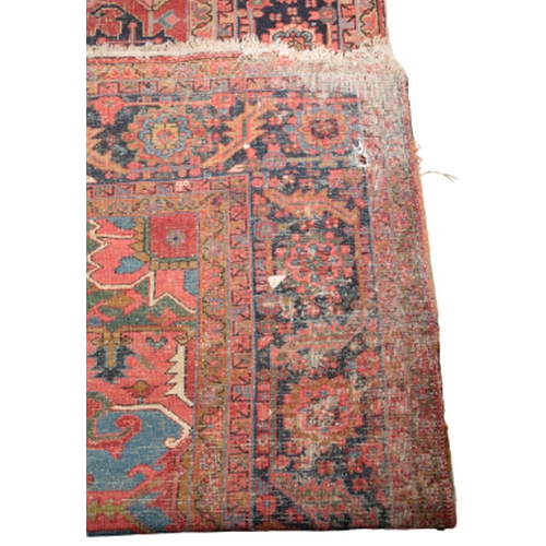 350 - A HERIZ CARPET early 20th century, the central geometric medallion on a red ground with all-over sty... 