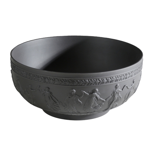 51 - A WEDGWOOD BLACK BASALT FRUIT BOWL in the dancing hours pattern, 11.5cm high x 25.5cm wide, together... 