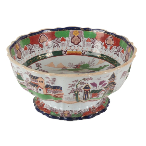 58 - A LARGE VICTORIAN REAL STONE CHINA BOWL the scalloped basin decorated with pagodas in mountainous la... 