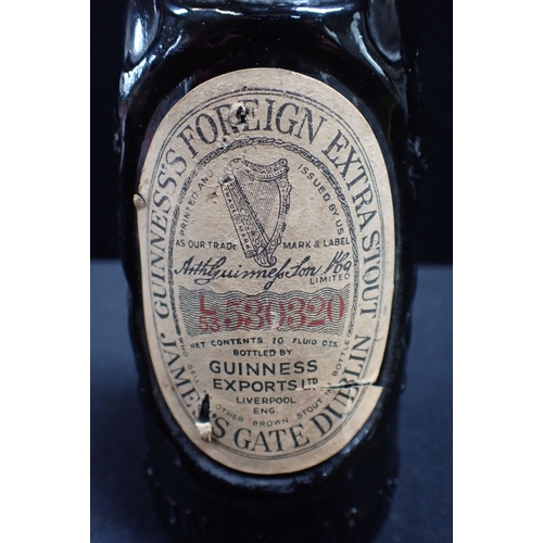 251 - A 1953 CORONATION SOUVENIR BOTTLE OF GUINNESS the bottle moulded with the Lion and Unicorn (with con... 