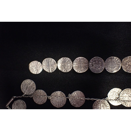 427 - A WHITE METAL'sHORT CROSS PENNY' NECKLACE hung with eighteen coins, together with a similar bracelet... 