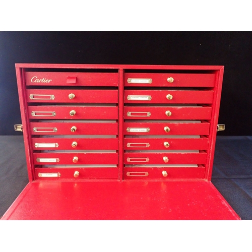 479 - A 'CARTIER' WATCH/JEWELLERY SHOP CASE, IN RED LEATHER the front flap enclosing 14 drawers 47cm wide ... 