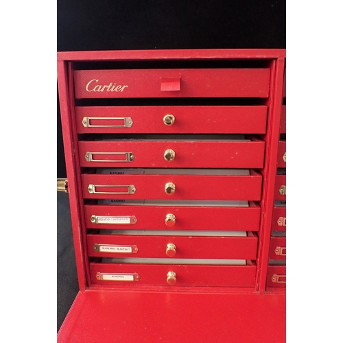 479 - A 'CARTIER' WATCH/JEWELLERY SHOP CASE, IN RED LEATHER the front flap enclosing 14 drawers 47cm wide ... 