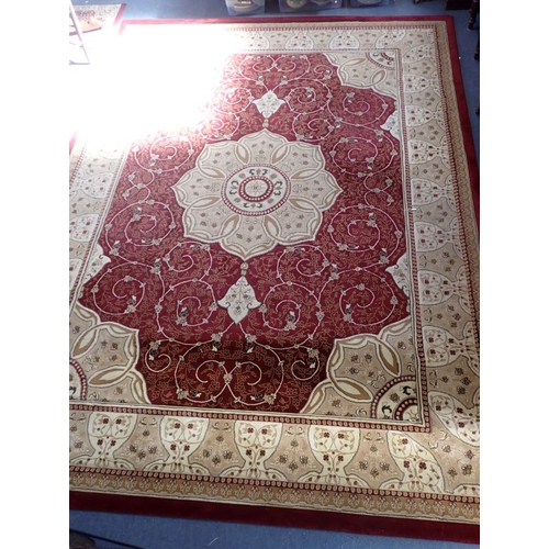 712 - A LARGE MACHINE-MADE PERSIAN STYLE CARPET with cream rose medallion 280 x 382cm (some wear to edge s... 