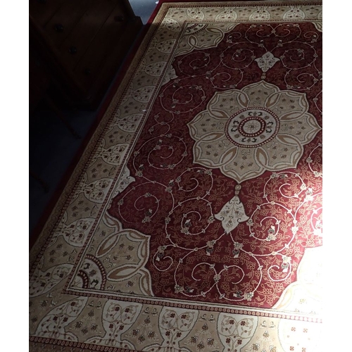 712 - A LARGE MACHINE-MADE PERSIAN STYLE CARPET with cream rose medallion 280 x 382cm (some wear to edge s... 