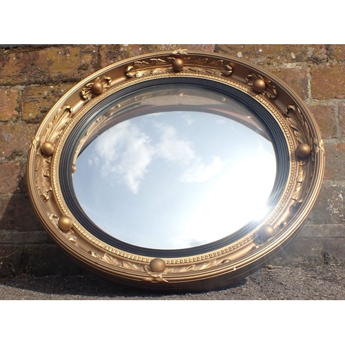 718 - A REGENCY STYLE CONVEX MIRROR with ball and acanthus moulded frame, by 'Atsonea' 47cm diam