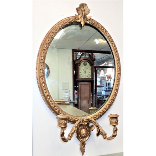 726 - AN EDWARDIAN WALL MIRROR WITH OVAL PLATE the rococo frame with broad rectangular oak surround, and b... 