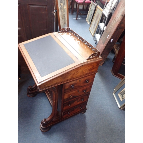 742 - A VICTORIAN WALNUT DAVENPORT with carved front supports and fretted gallery 54cm wide (damage)