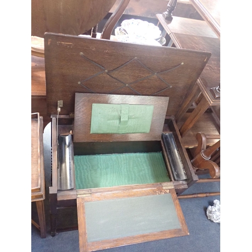 763 - A 1920S OAK WORK/WRITING TABLE on barley-twist legs, the top revealing a hinged writing surface and ... 