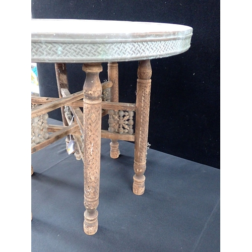 791 - A PERSIAN BRASS-TOPPED TABLE with folding legs