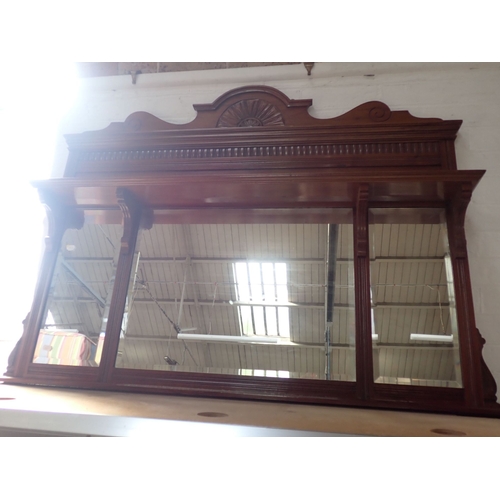 815 - A VICTORIAN MAHOGANY OVERMANTEL MIRROR with triple bevelled plates, plate shelf and carved pediment ... 