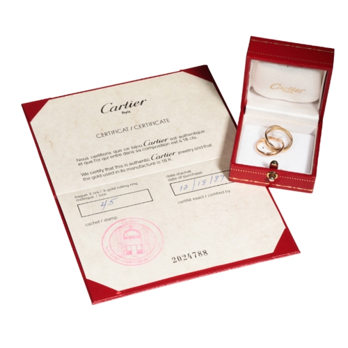 1 - CARTIER: A ROLLING RING formed as three conjoined tri-colour rings, ring size H, in a fitted 