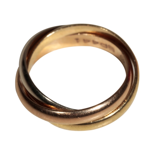 1 - CARTIER: A ROLLING RING formed as three conjoined tri-colour rings, ring size H, in a fitted 
