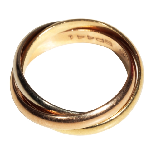1 - CARTIER: A ROLLING RING formed as three conjoined tri-colour rings, ring size H, in a fitted 
