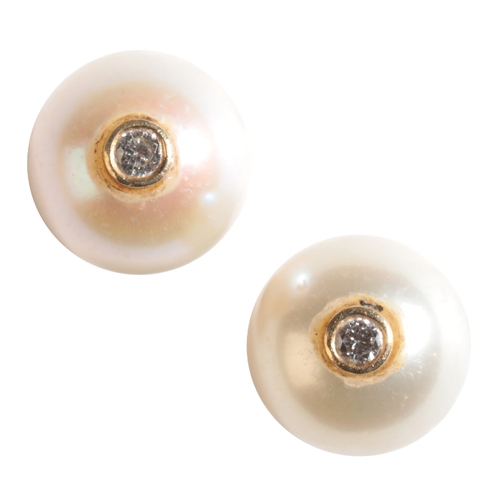 19 - A PAIR OF CULTURED PEARL EAR STUDS each set with a single diamond