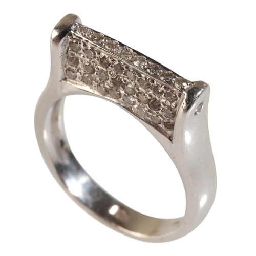 38 - A DIAMOND RING set in white 14ct gold, flanked to both sides with pave-set diamonds, and a further d... 