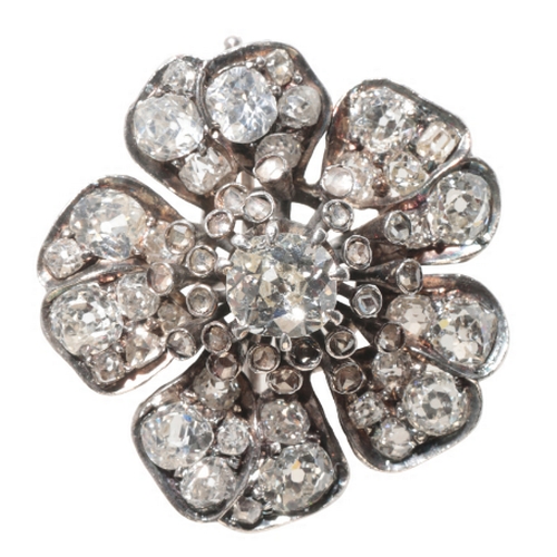 45 - A DIAMOND FLOWER HEAD BROOCH the central cushion-cut diamond within a border of stamens, each set wi... 