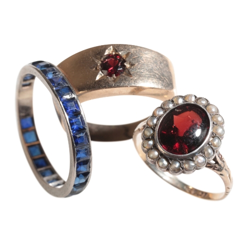 58 - A SAPPHIRE EXTENDED FULL ETERNITY RING together with a 9ct gold garnet and seed pearl dress ring, an... 