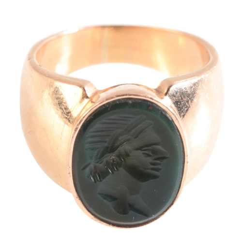 66 - A GOLD SIGNET RING (indistinct 750 mark), set with a Haematite Intaglio, size M½, (c.12.56g gross we... 