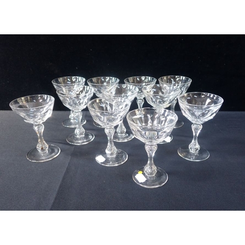 280 - ELEVEN EDWARDIAN PANEL CUT CHAMPAGNE COUPES with waisted stems (one chipped rim)