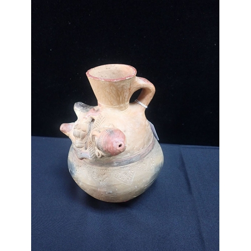 357 - A PRE-COLUMBIAN STYLE POTTERY VESSEL moulded with a reclining figure 22.5cm high