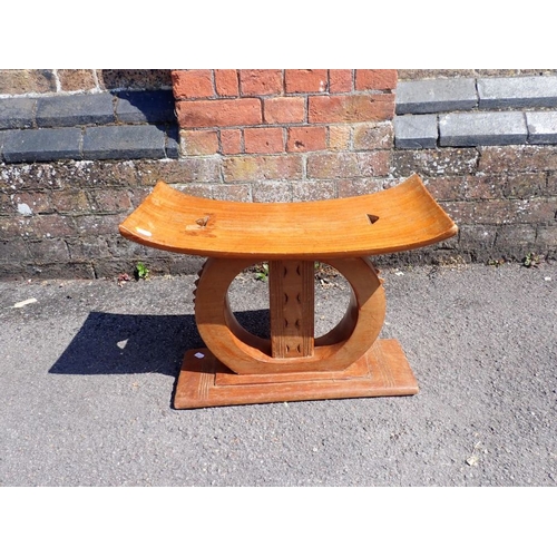 362 - AN ASHANTI HARDWOOD STOOL 53cm wide