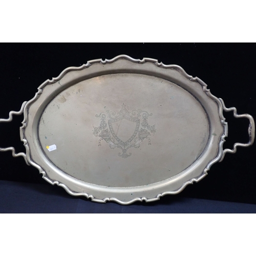 363 - A SILVER-PLATED TRAY WITH ENGRAVED VACANT SHIELD raised border and handles 69cm wide