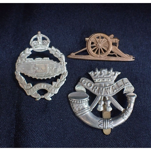 456 - A TANK REGIMENT CAP BADGE with two others, one Cornwall,