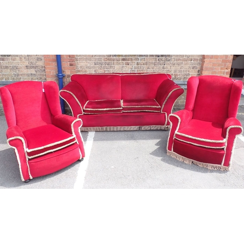 680 - A 1920S SOFA, WITH LOW BACK AND SPLAYED ARMS, ON BUN FEET 198cm wide, and two wing armchairs, with m... 