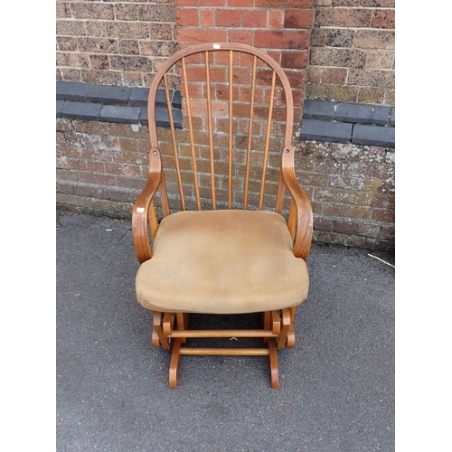 684 - A HOOP-BACKED BENTWOOD ROCKING ARMCHAIR with squab cushion 60cm wide