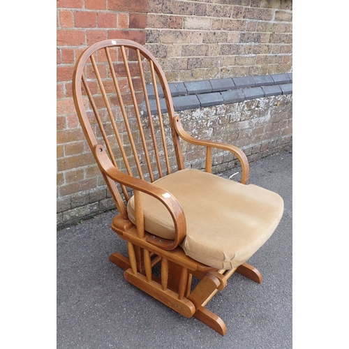 684 - A HOOP-BACKED BENTWOOD ROCKING ARMCHAIR with squab cushion 60cm wide