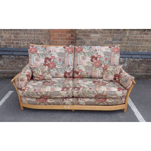 685 - AN ERCOL ELM 'RENAISSANCE' SOFA with floral covered cushions 192cm wide