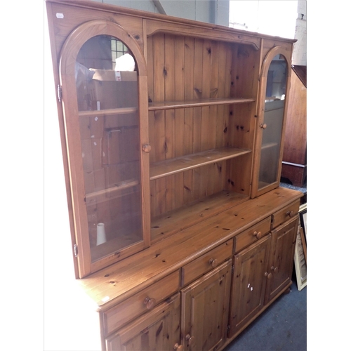 689 - A PINE DRESSER, THE RACK WITH GLAZED CUPBOARDS 174cm wide