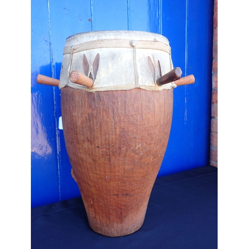 126 - A TRIBAL HARDWOOD DRUM the skin held with long pegs 53cm high