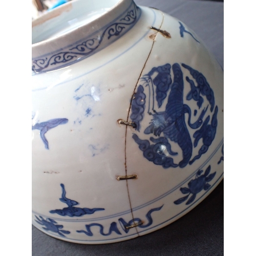 275 - A 19TH CENTURY CHINESE BOWL decorated with cranes and objects, within lines, in underglaze blue 27cm... 