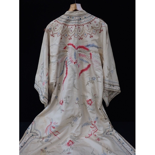 288 - A CHINESE SILK ROBE, QING , EMBROIDERED WITH FLOWERS AND PHOENIX with gilt brass buttons (some damag... 