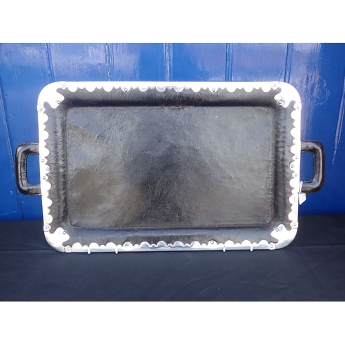 304 - A LEATHER TRAY, WITH SHAPED SILVER MOUNTS the mounts with import marks, maker's mark worn, 62 x 40.5... 