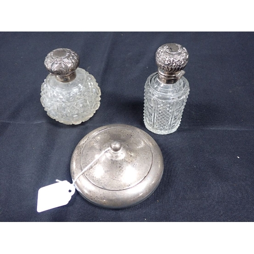 309 - TWO SILVER TOPPED SCENT BOTTLES with a silver rimmed and lidded pot