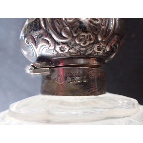 309 - TWO SILVER TOPPED SCENT BOTTLES with a silver rimmed and lidded pot