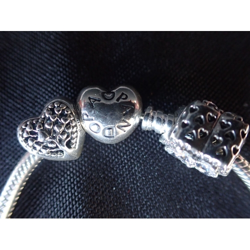316 - PANDORA: A SILVER BRACELET WITH TWO BEADS